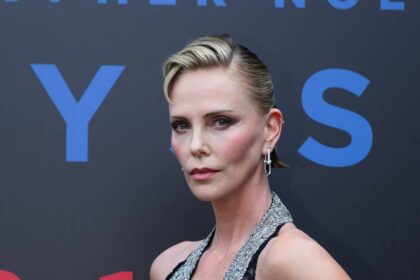 Charlize Theron, 50, steals the show in plunging lace gown and $50k jewels