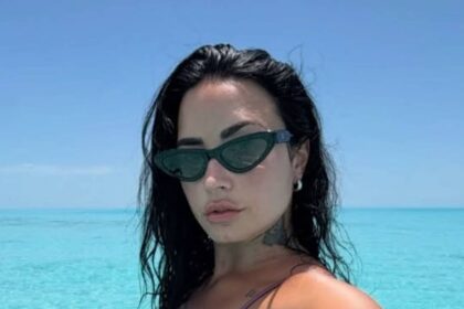 Demi Lovato shows off tattoos in tiny string bikini
