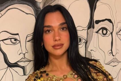 Dua Lipa stuns in gold plunging top at family wedding