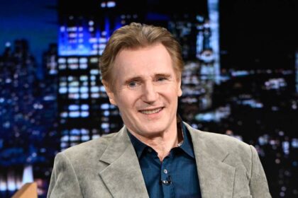 Liam Neeson, 74, holds hands with striking younger costar for red carpet appearance