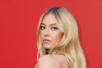 Sydney Sweeney channels Pamela Anderson in plunging red swimsuit on romantic getaway with Scooter Braun