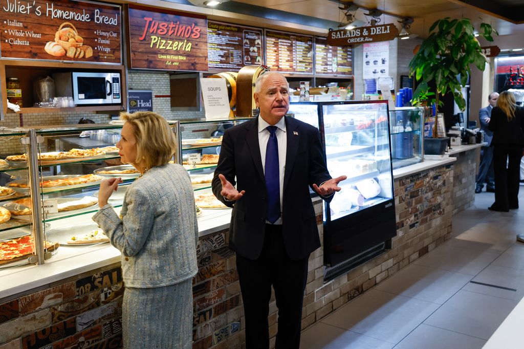 Tim Walz and his wife Gwen Walz (L) visit Justino's Pizzeria after his debate with Republican vice presidential candidate Sen. JD Vance