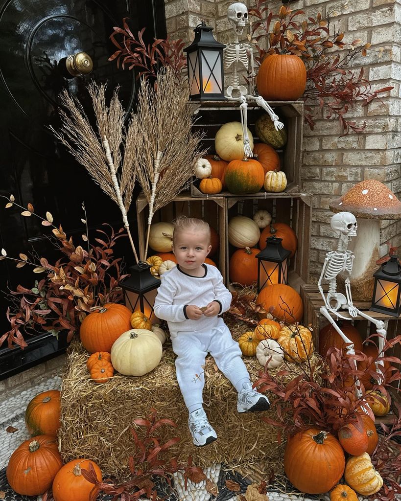 molly mae's daughter Babmbi sitting on a hayball surrounded by pumpkins