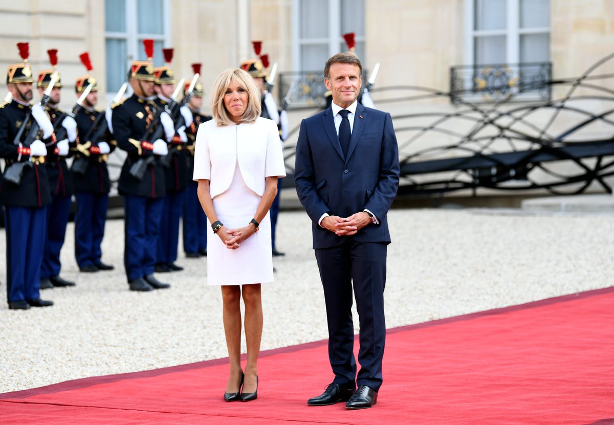  French President Emmanuel Macron and his wife Brigitte Macron wait to welcome guests during a welcome ceremony for international dignitaries and guests attending the opening ceremony of Paris 2024 Paralympic Games at Elysee Palace on August 28, 2024 in Paris, France. (Photo by Li Yang/China News Service/VCG via Getty Images)