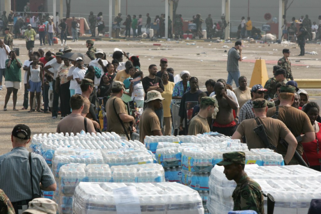 Hurricane Katrina victims line up to receive food and water from National Guard units outside the convention center Friday, Sept. 2, 2005, in New Orleans. La. (Photo by Brett Coomer/Houston Chronicle) (Photo by Brett Coomer/Houston Chronicle via Getty Images)