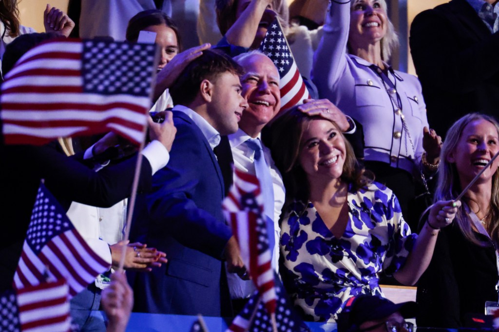 CHICAGO, ILLINOIS - AUGUST 22: Democratic vice presidential nominee Minnesota Gov. Tim Walz (C) hugs his children Gus Walz (L) and Hope Walz (R) during the final day of the Democratic National Convention at the United Center on August 22, 2024 in Chicago, Illinois. Delegates, politicians, and Democratic Party supporters are gathering in Chicago, as current Vice President Kamala Harris is named her party's presidential nominee. The DNC takes place from August 19-22. (Photo by Chip Somodevilla/Getty Images)