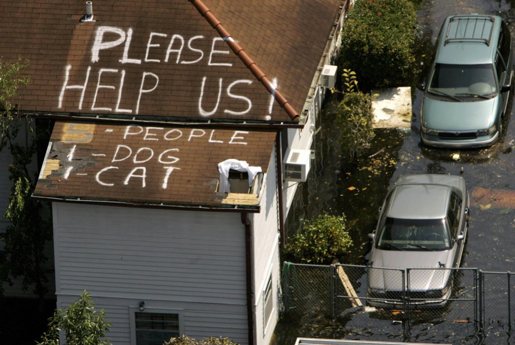 New Orleans, UNITED STATES:  A plea for help appears on the roof of a home flooded in the aftermath of Hurricane Katrina in New Orleans, Louisiana, 04 September 2005. New Orleans began counting its dead 04 September as US troops turned to the gruesome task of harvesting bloated corpses from the hurricane-torn city's flooded streets and homes.   AFP PHOTO/POOL/Robert GALBRAITH  (Photo credit should read ROBERT GALBRAITH/AFP via Getty Images)