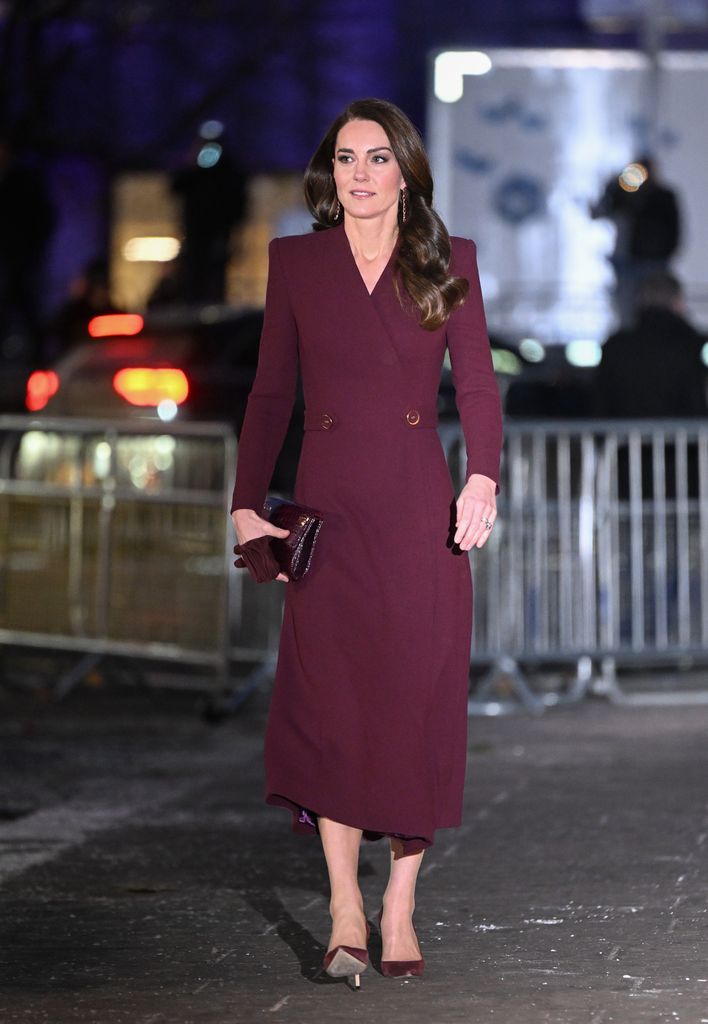 Kate in a burgundy coat dress and heels