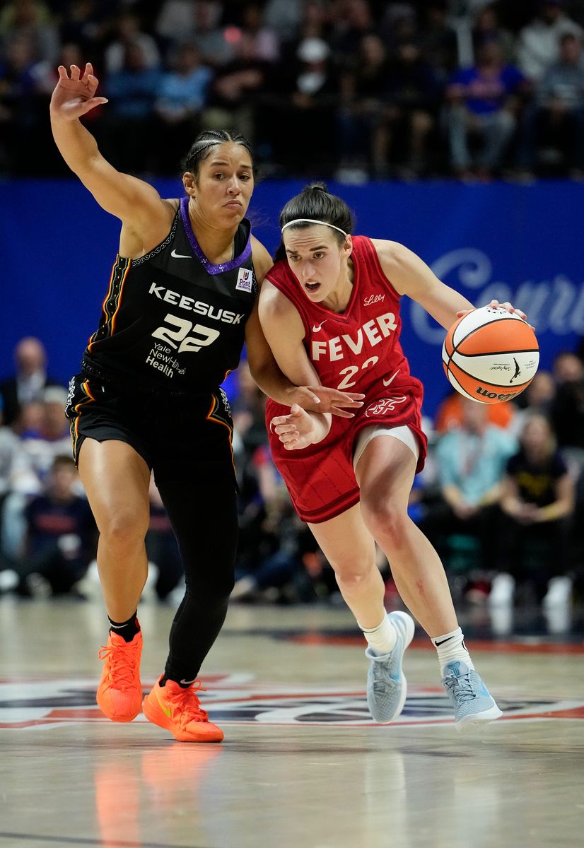  Caitlin Clark, #22 of the Indiana Fever, drives on Veronica Burton #22 of the Connecticut Sun during the fourth quarter of Game Two of the 2024 WNBA Playoffs first round at Mohegan Sun Arena on September 25, 2024, in Uncasville, Connecticut. The Connecticut Sun won 87-81 over the Indiana Fever. (Photo by Joe Buglewicz/Getty Images)