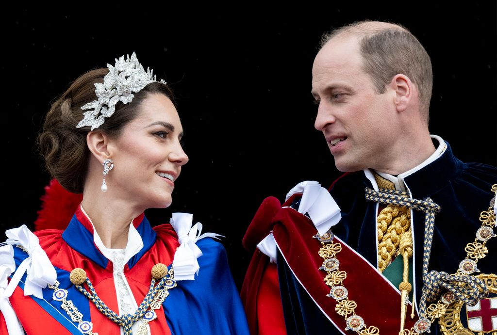 William and Kate looking at each other on palace balcony at the coronation