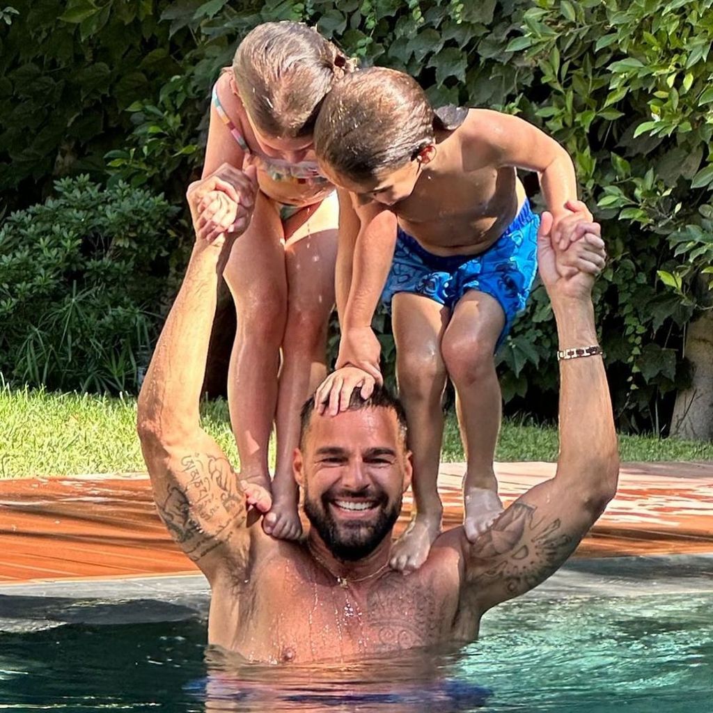 Ricky Martin hoists his two children Lucia and Renn on his shoulders in the pool, shared on Instagram