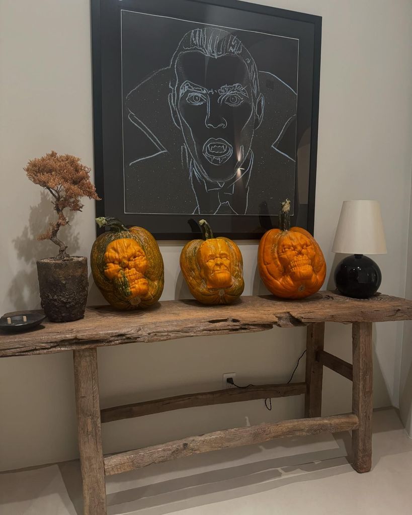 Three pumpkins and a Dracula painting 