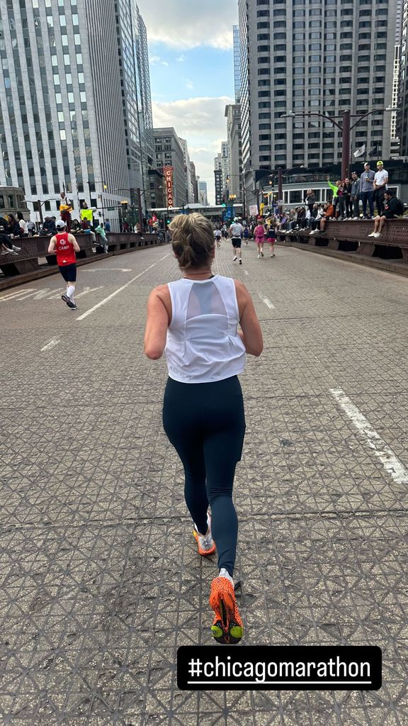 T.J. Holmes shares a photo of girlfriend Amy Robach running the Chicago Marathon, shared on Instagram Stories