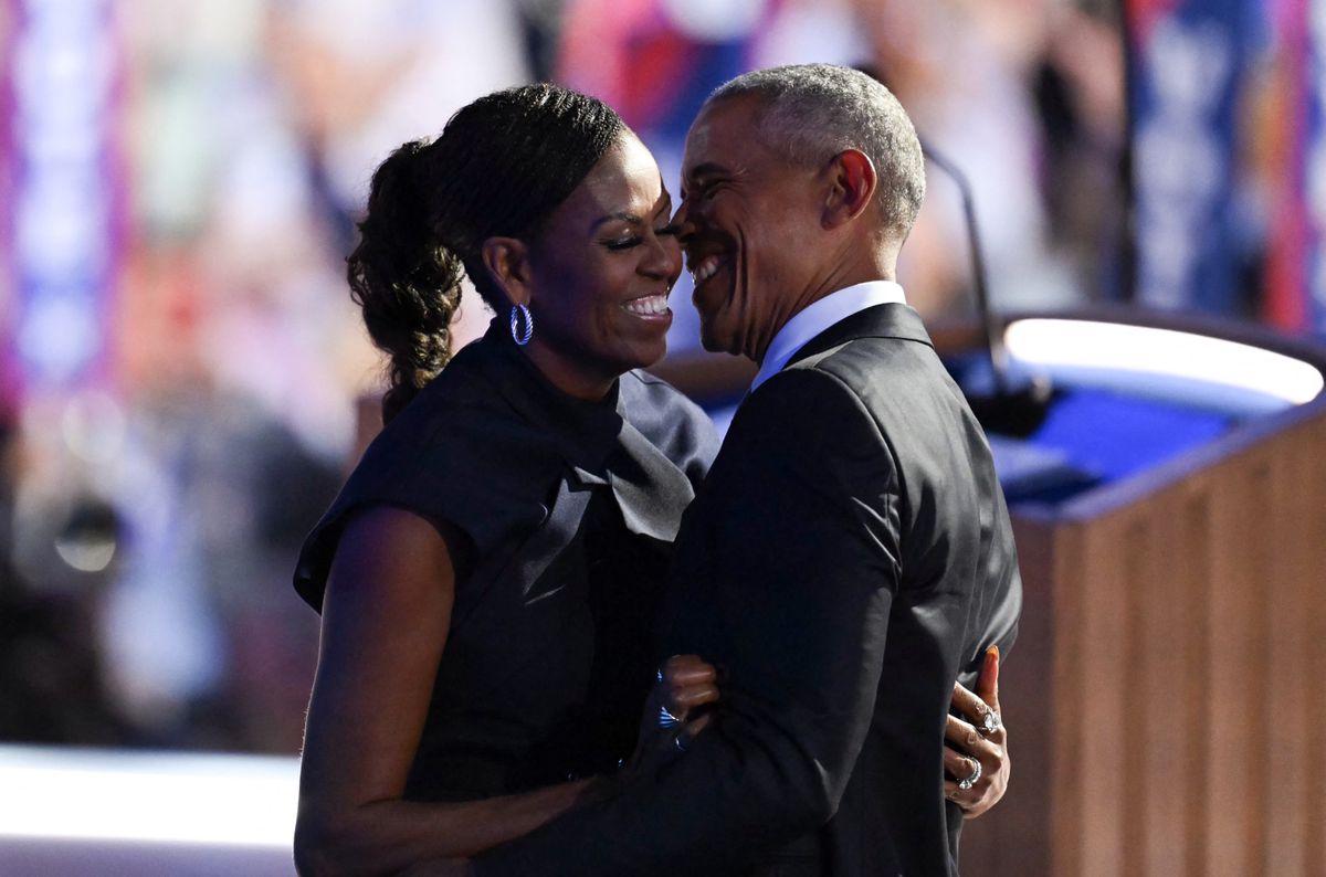 Former US President Barack Obama hugs his wife and former First Lady Michelle Obama after she introduced him on the second day of the Democratic National Convention (DNC) at the United Center in Chicago, Illinois, on August 20, 2024. Vice President Kamala Harris will formally accept the party's nomination for president at the DNC which runs from August 19-22 in Chicago. (Photo by ANDREW CABALLERO-REYNOLDS / AFP) (Photo by ANDREW CABALLERO-REYNOLDS/AFP via Getty Images)