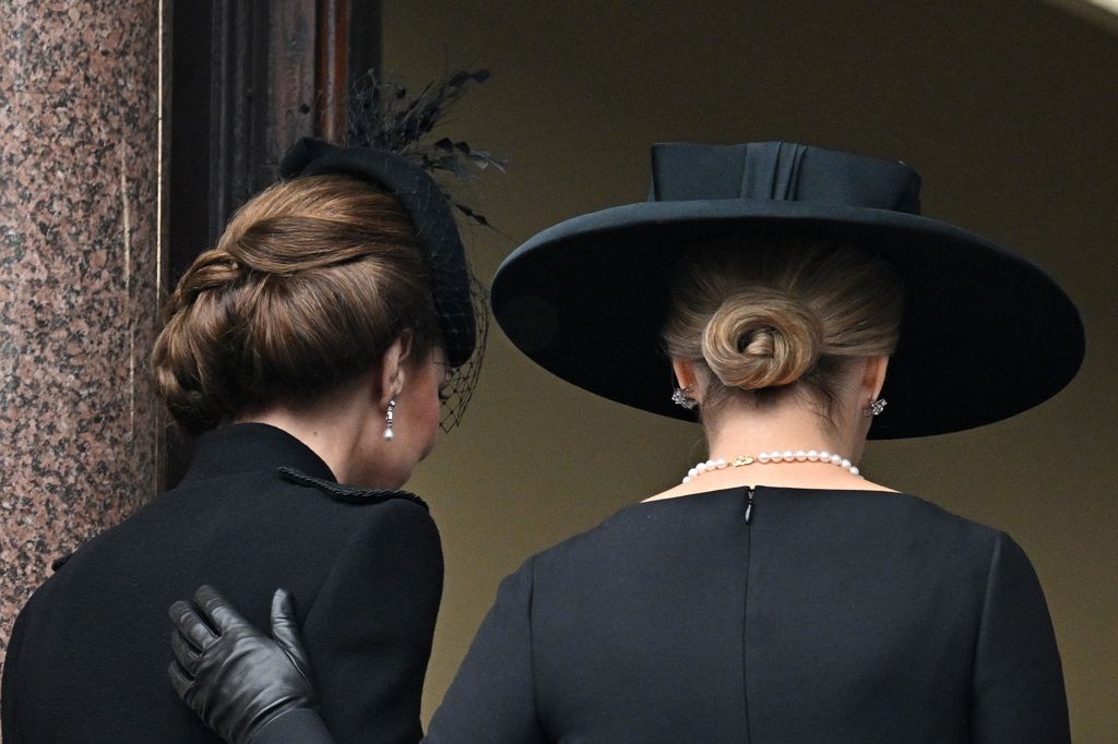 the Duchess of Edinburgh lays a supportive hand on Kate's back during the Service Of Remembrance