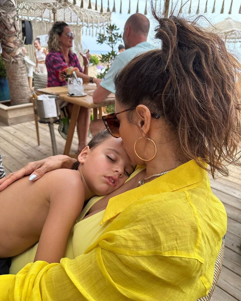 Eva Longoria kissing her son's forehead whilst he sleeps in her arms