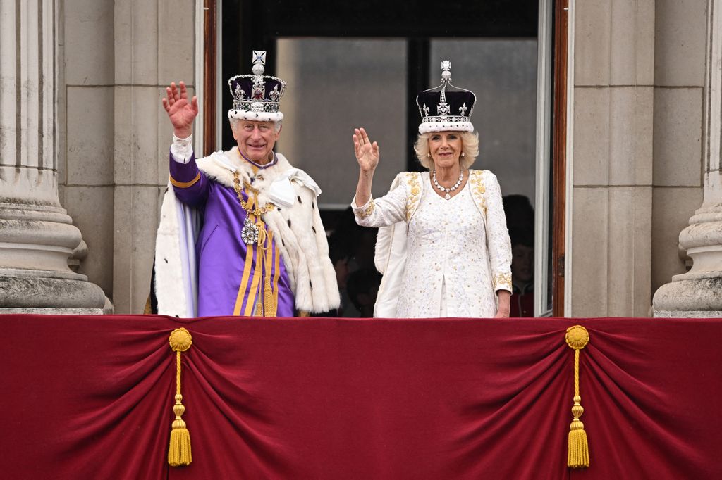 King Charles and Queen Camilla waving from the Buckingham Palace balcony