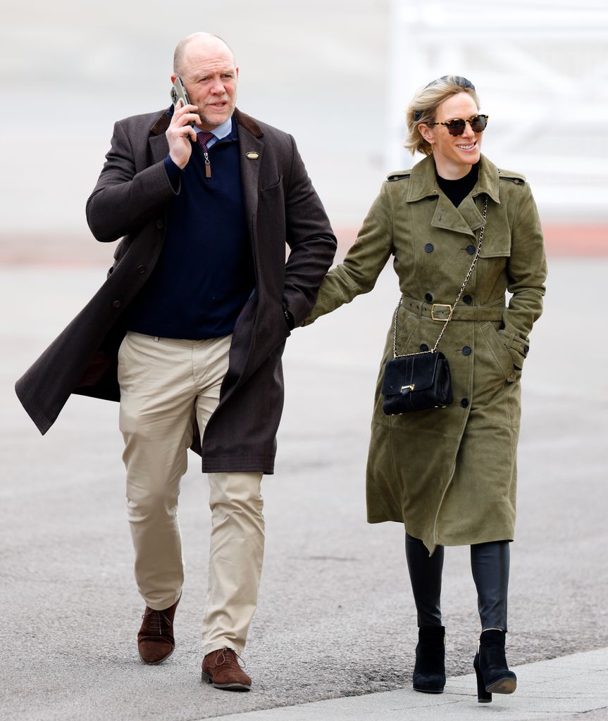 Mike Tindall and Zara Tindall walking at Cheltenham Racecourse