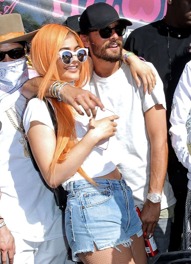 Kylie Jenner with orange hair hugging Scott Disick