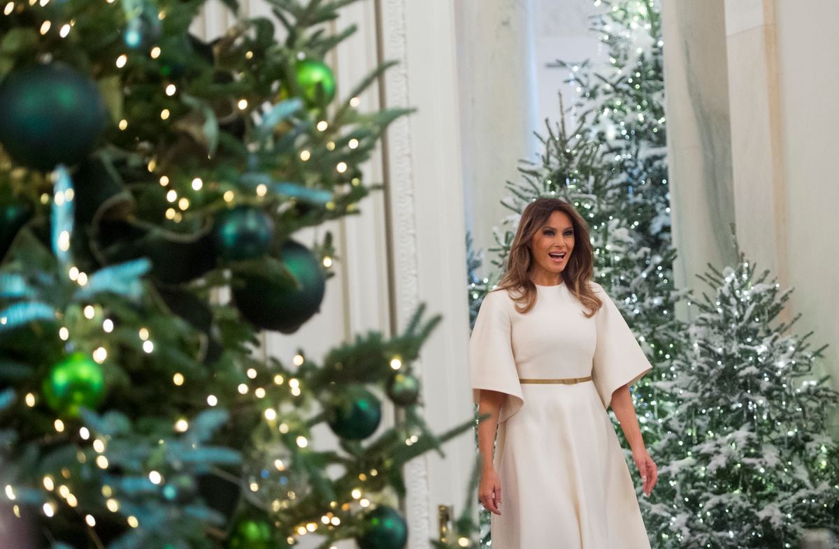 Melania Trump walks into the East Room as she tours Christmas decorations at the White House in Washington, DC.