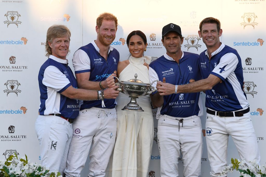 group of people posing for photo at polo match