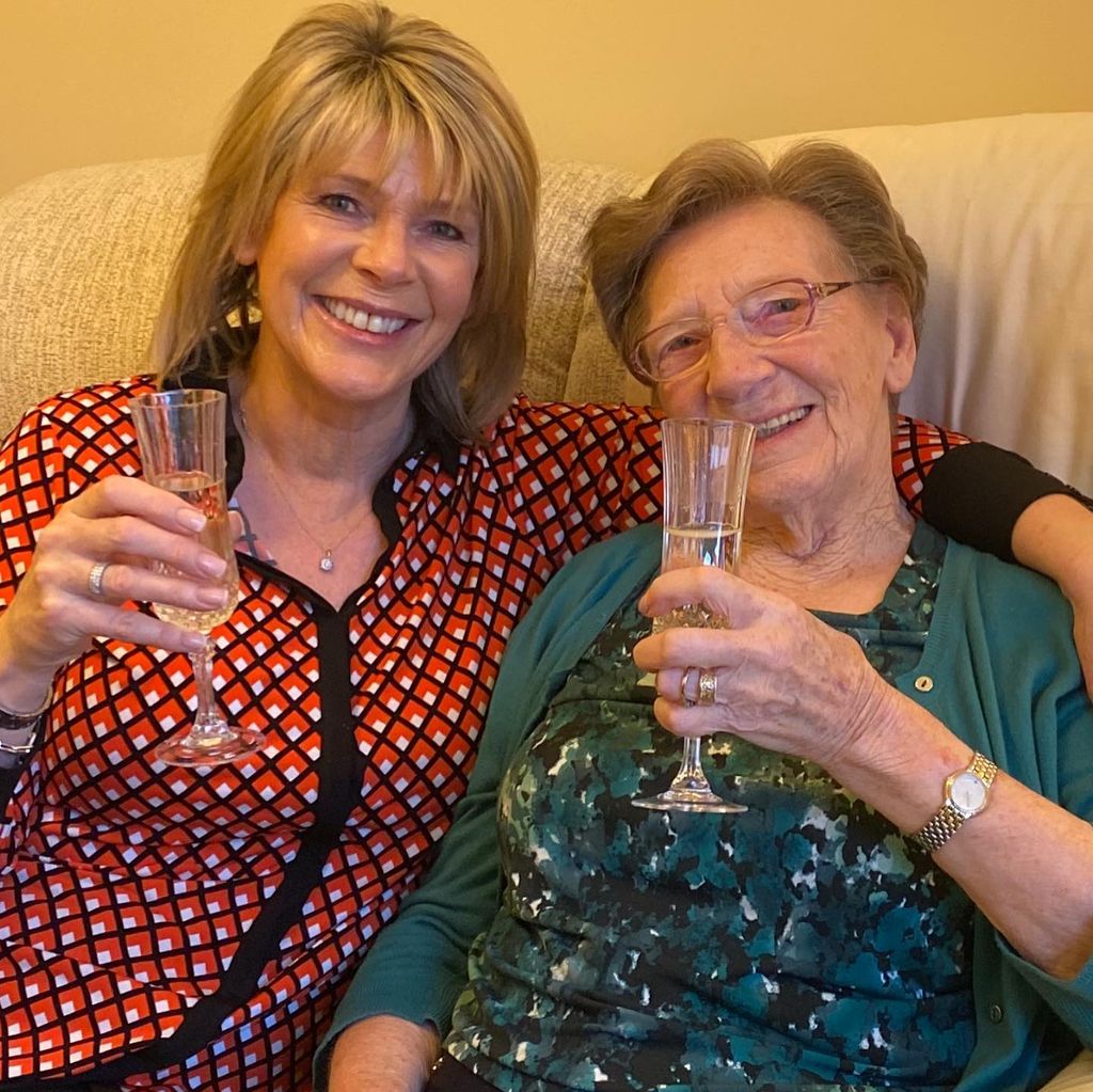 Ruth Langsford with her mum, Joan, on a sofa raising a glass