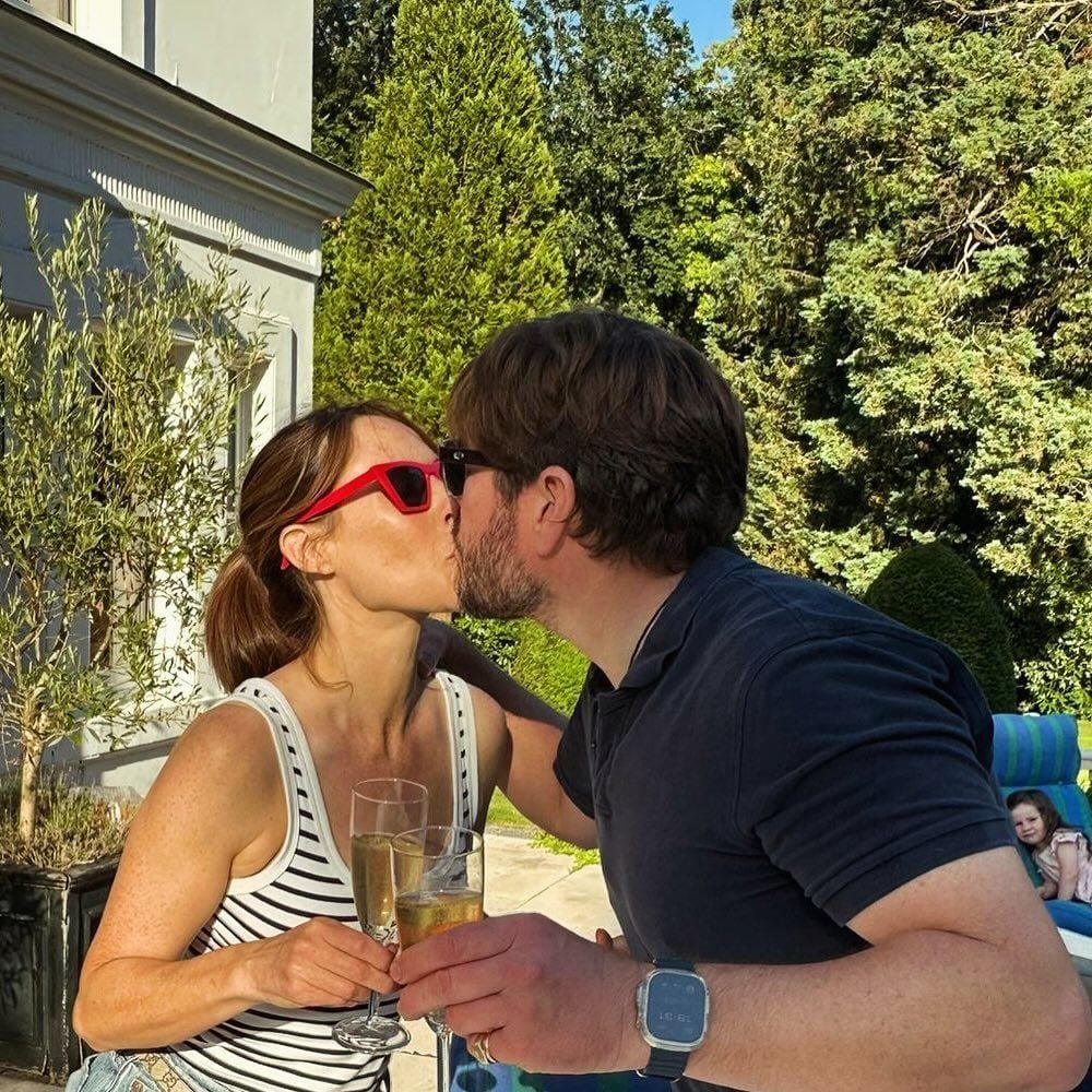 Alex Jones kissing her husband Charlie Thomson