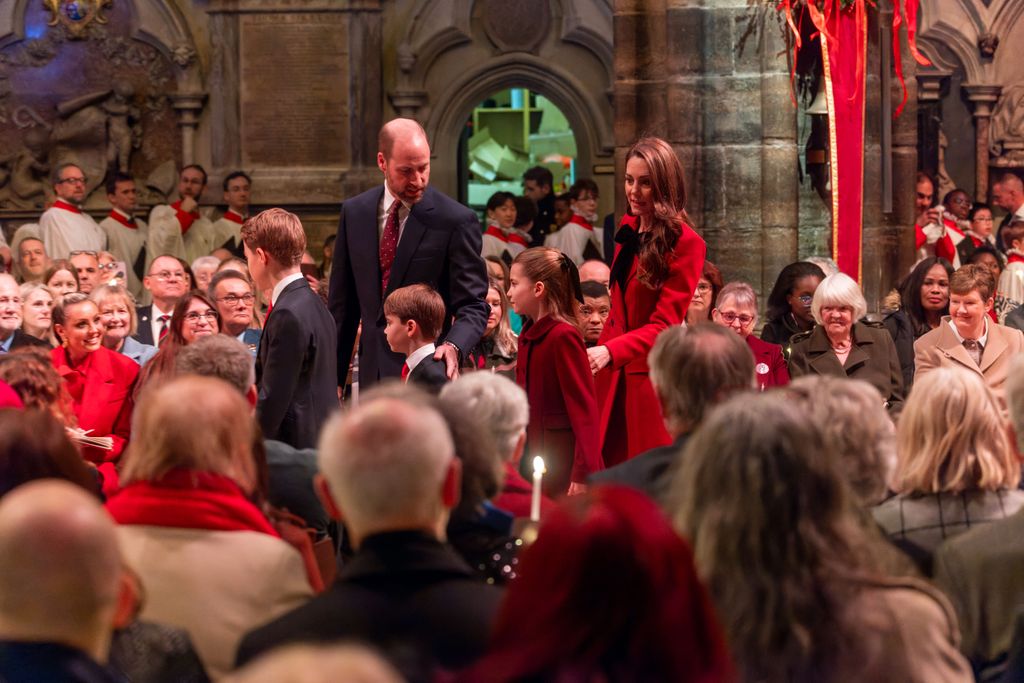 Prince William putting a comforting arm around Prince Louis