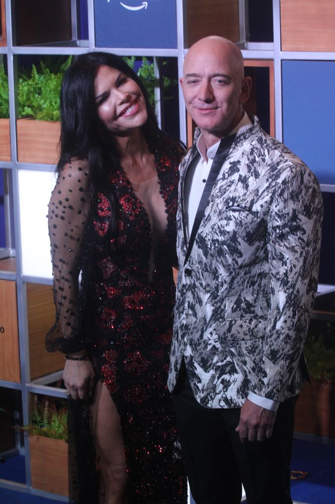 Amazon CEO Jeff Bezos, right along with American news anchor Lauren Sanchez poses for photographs during a blue carpet event organized by Amazon Prime Video in Mumbai, India on January 16, 2020.