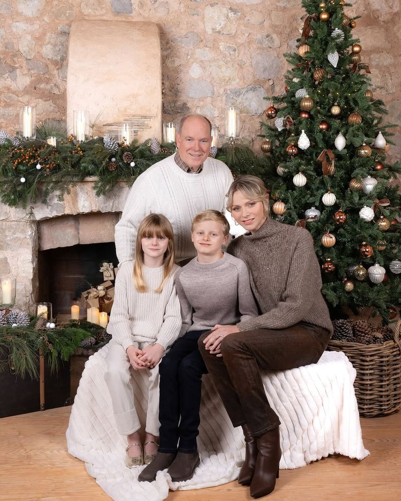 Prince Albert and Princess Charlene with their two kids posing in front of a Christmas tree