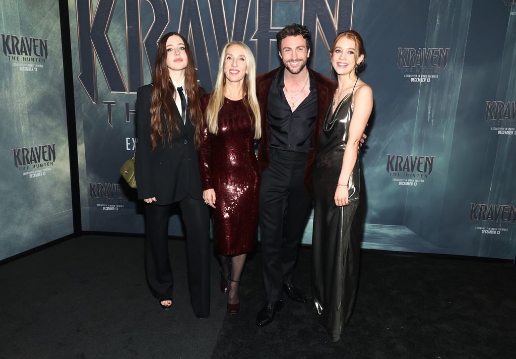 Sam Taylor-Johnson and Aaron Taylor-Johnson pose with daughters on red carpet