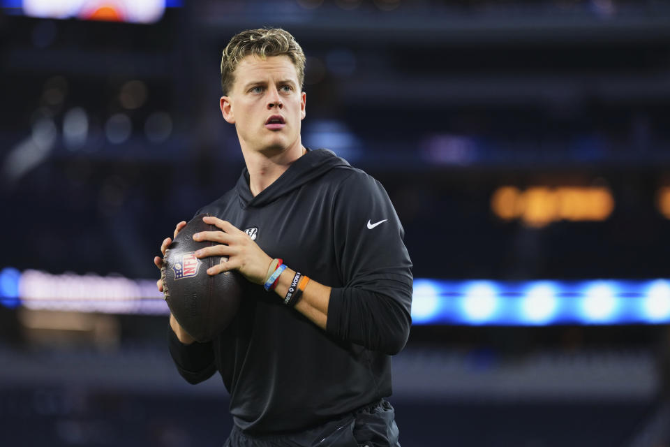  Joe Burrow gets ready to throw a football during warm-ups before the game against the Cowboys.