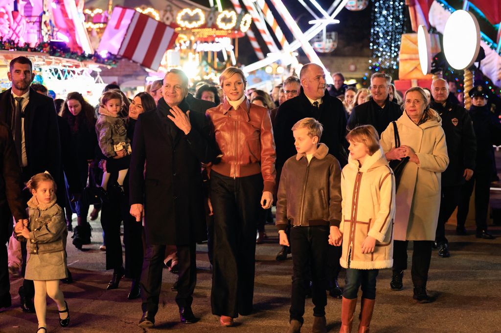 Princess Charlene of Monaco flanked by Monaco mayor Georges Marsan in Christmas village 