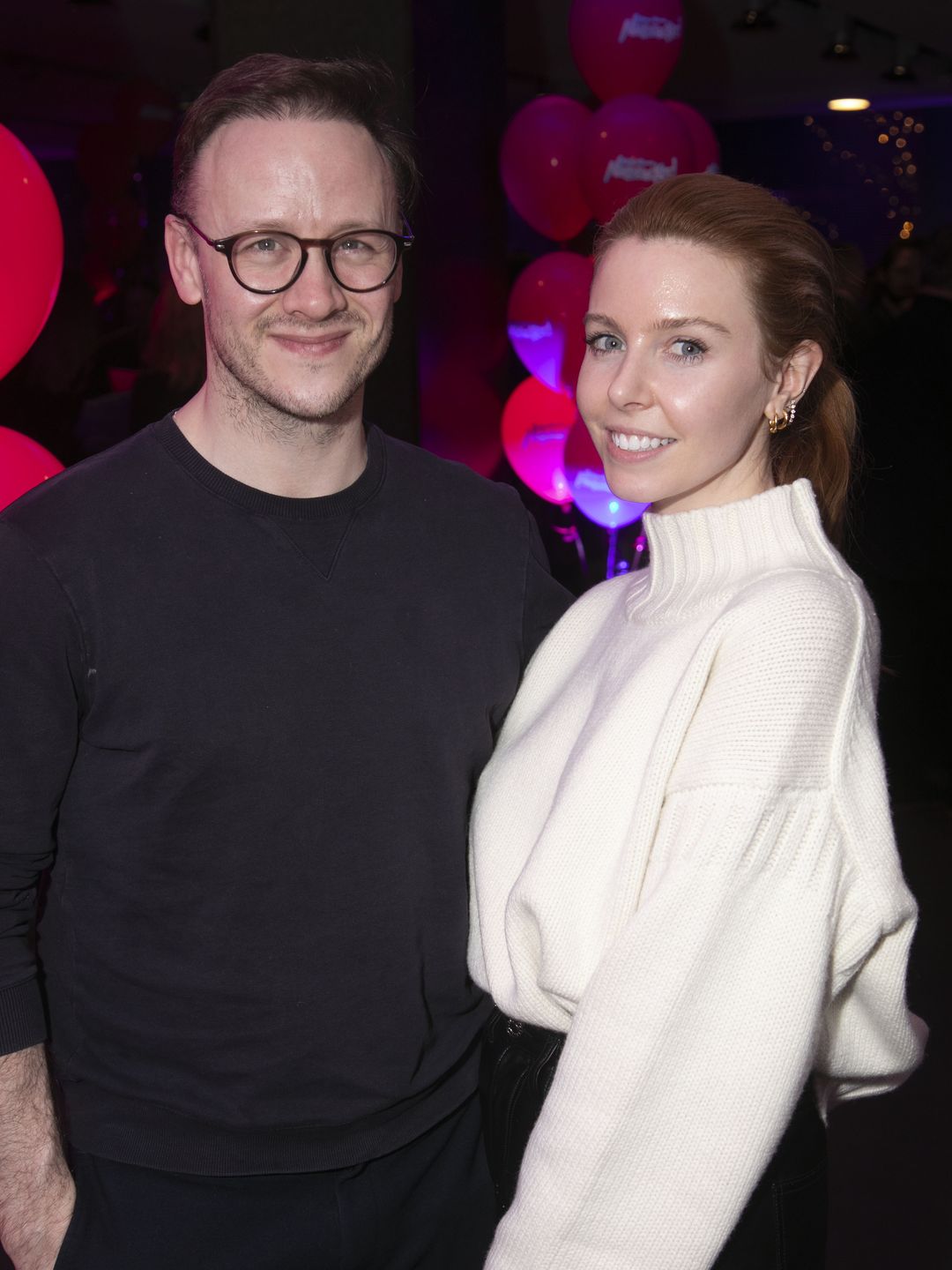 Kevin Clifton in a black jumper standing with Stacey Dooley in a white turtleneck