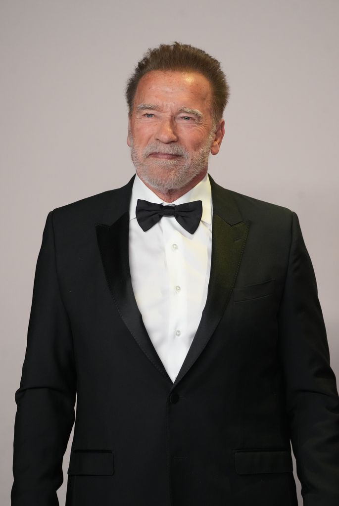 Arnold Schwarzenegger poses in Oscars press room 