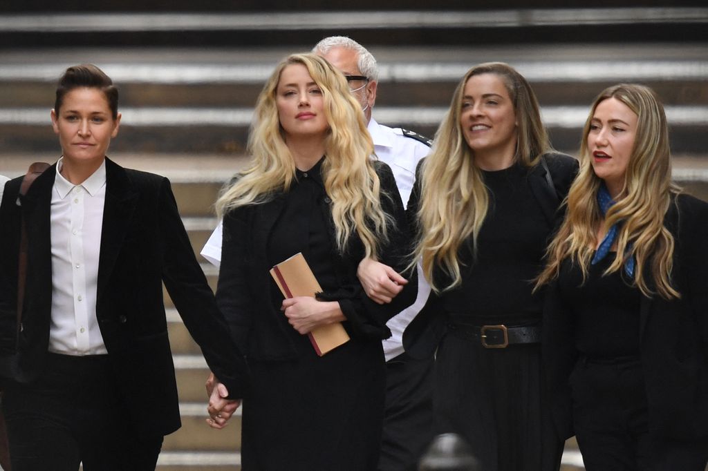 US actress Amber Heard (C) leaves the High Court with partner Bianca Butti (L)