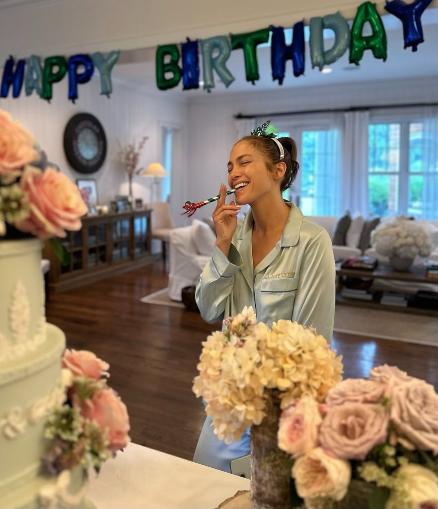 Jennifer Lopez posed with her birthday cake after her Bridgerton-inspired party