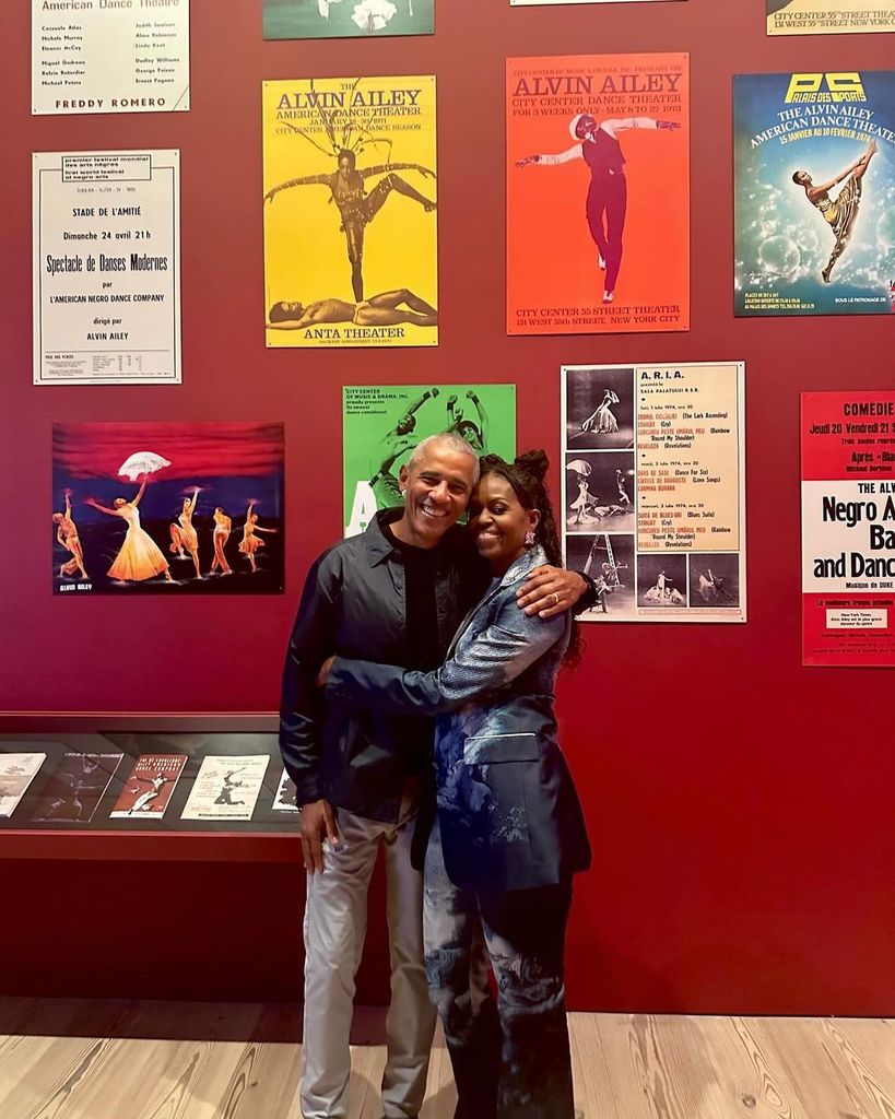 Michelle and Barack Obama pose with their arms around each other in the Whitney Museum