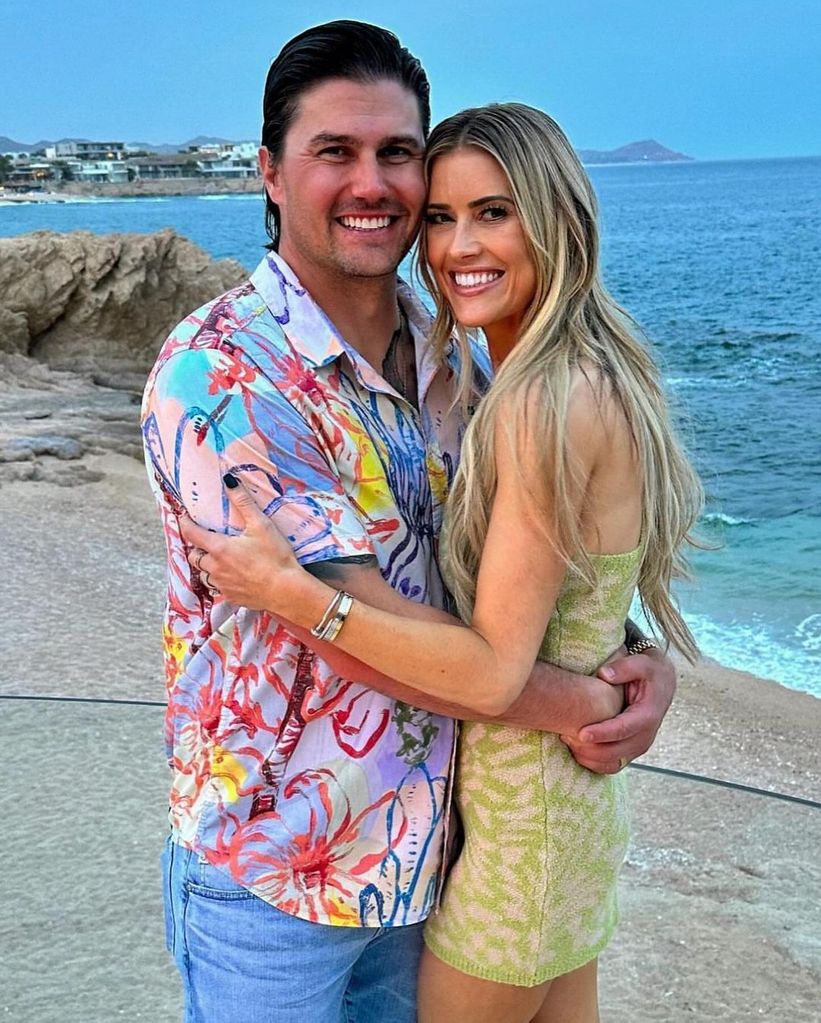 Christina Hall and Josh Hall pose on the beach in Mexico