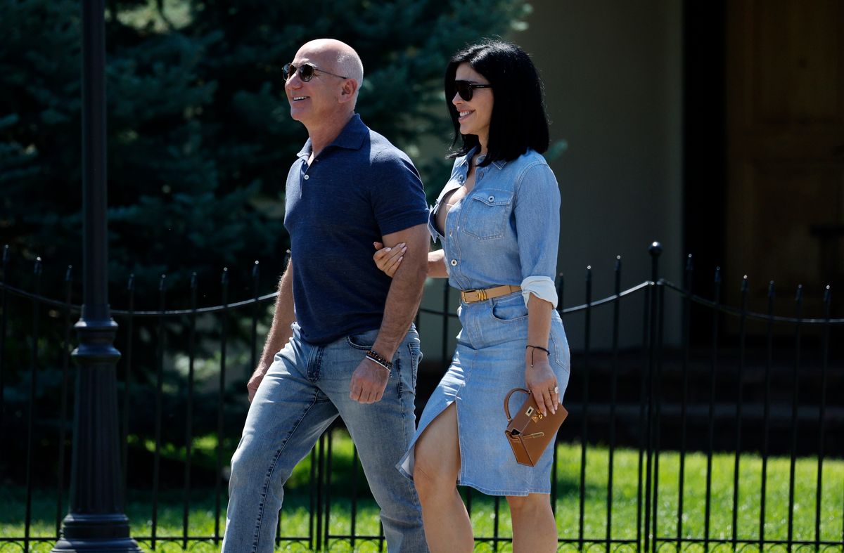 Jeff Bezos, founder of Amazon.com Inc., and Lauren Sanchez walk after the morning session during the Allen & Company Sun Valley Conference on July 11, 2024 in Sun Valley, Idaho. 