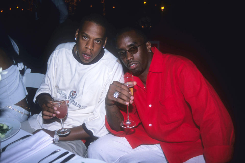 Carter and Sean Diddy Combs sit at a table during a party in 2000.