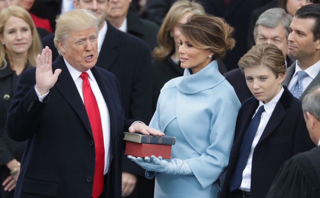 U.S. President Donald Trump takes the oath of office as his wife Melania Trump holds the bible on January 20, 2017