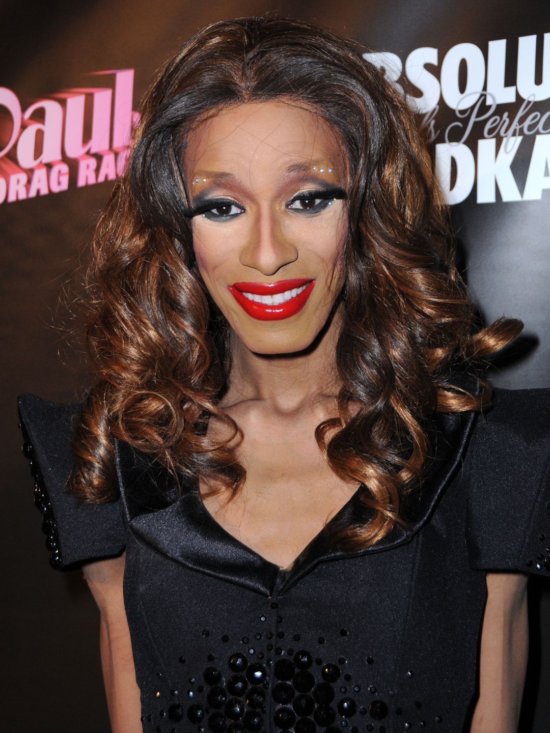 Sahara Davenport in a brunette wig and black outfit