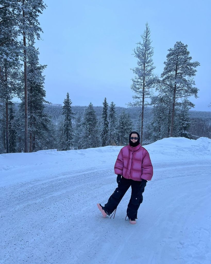 woman posing in pink puffer jacket 