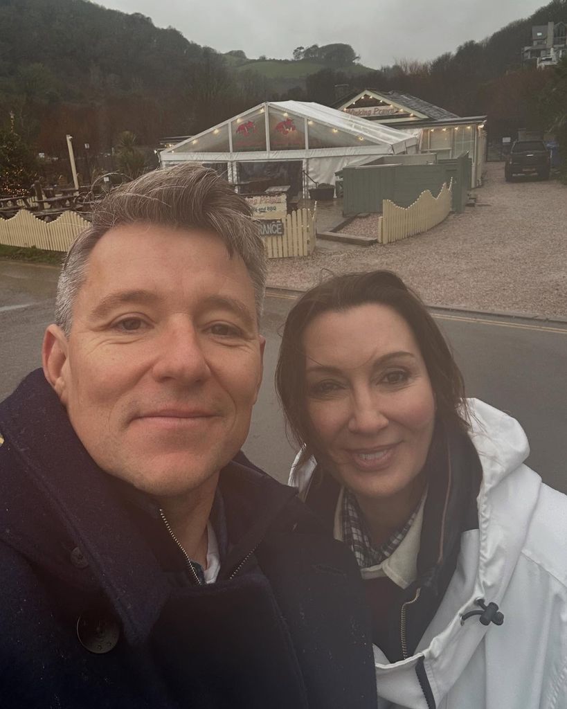 couple posing for selfie outside pub