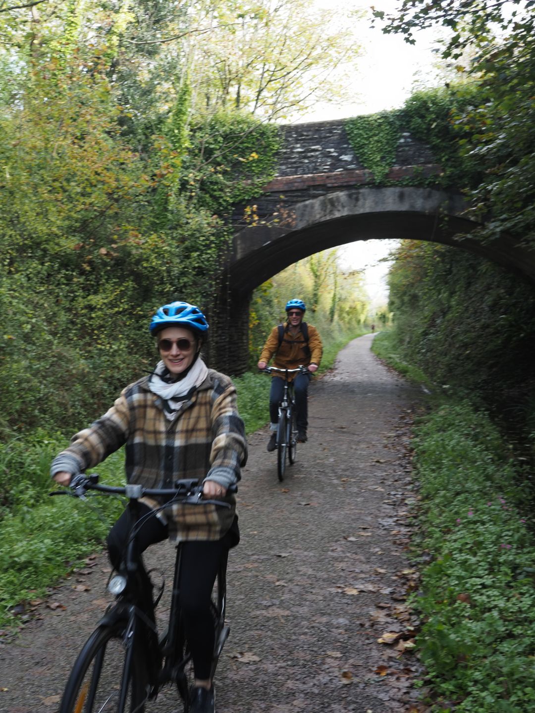 Two people cycling down the Camel Trail in Cornwall