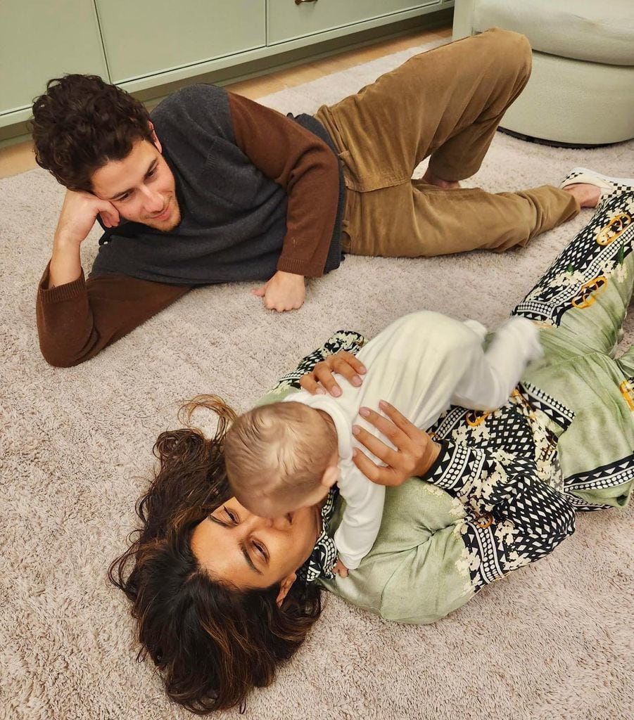 priyanka chopra holding daughter malti on floor with nick jonas