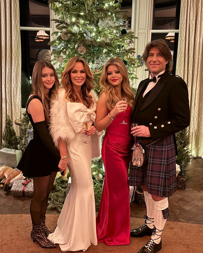 family posing by christmas tree