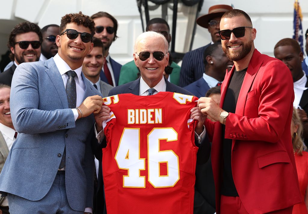 Quarterback Patrick Mahomes (L) and tight end Travis Kelce of the NFL Kansas City Chiefs present U.S. President Joe Biden a team jersey at the White House on June 05, 2023