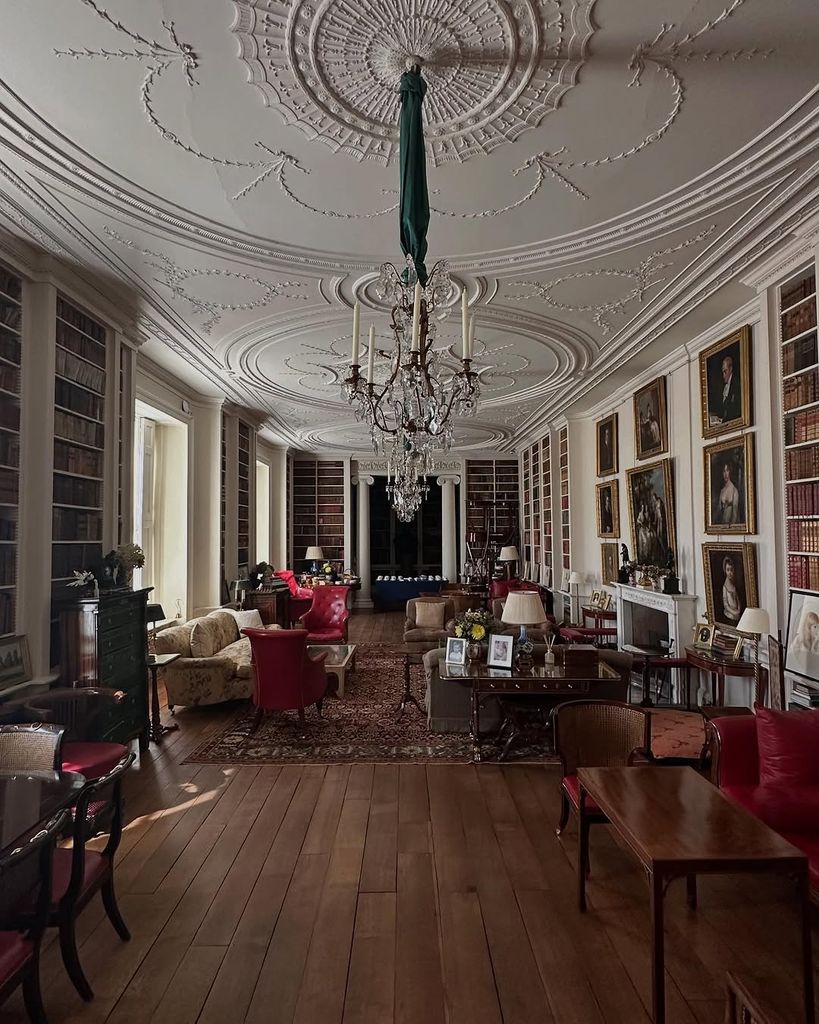 big library with many chairs and chandelier on ceiling